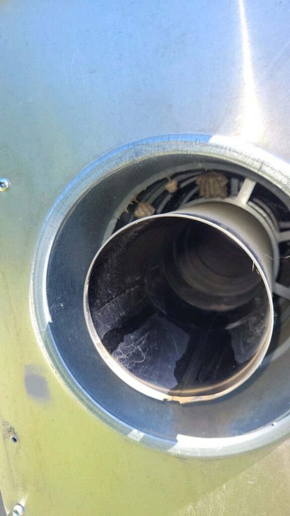 Close-up image of a jet engine intake with visible internal blades and a metallic-green nacelle