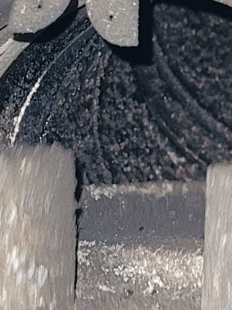 Close-up of creosote buildup inside a chimney liner.