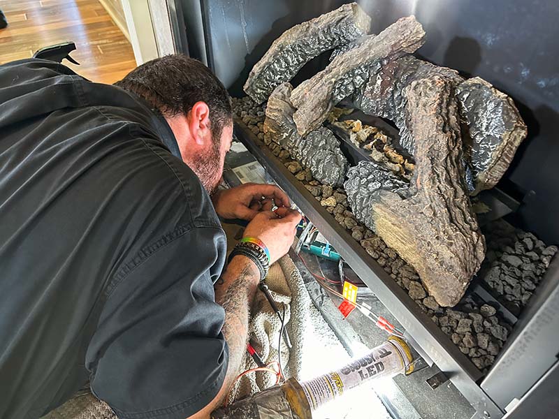 Technician working on gas fireplace