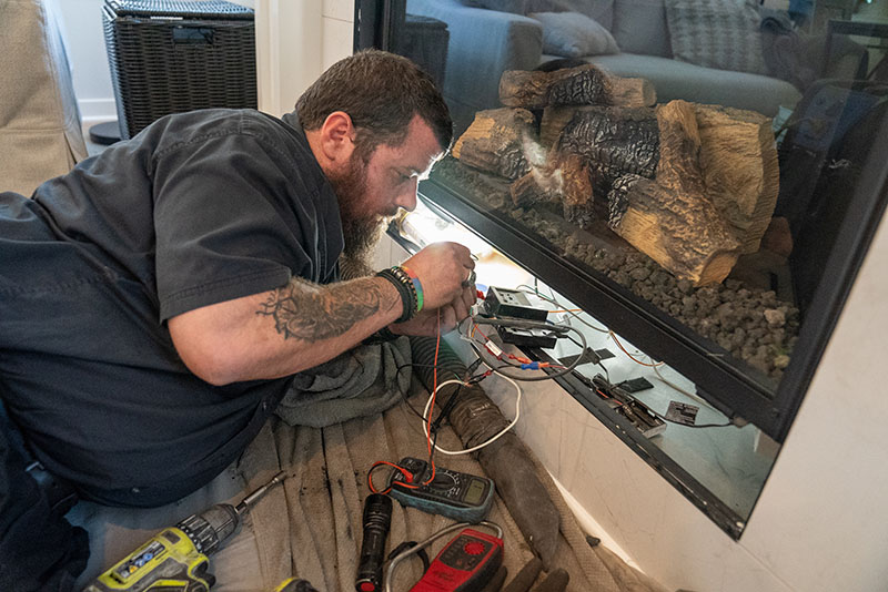 Technician working on gas fireplace